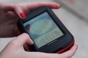 A close-up photograph of a hand-held GPS device.